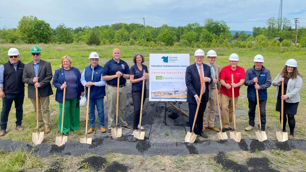 Group of stakeholders with shovels ready to break ground.