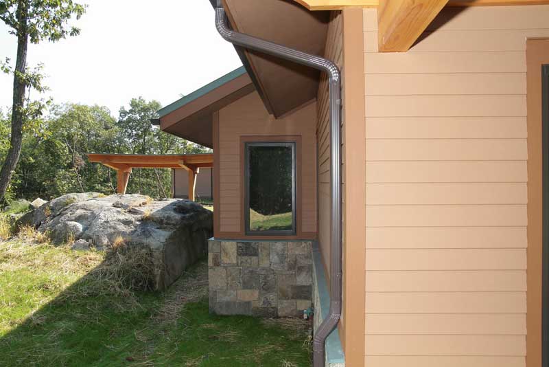 Image show natural rock outcroppings complimenting the home.