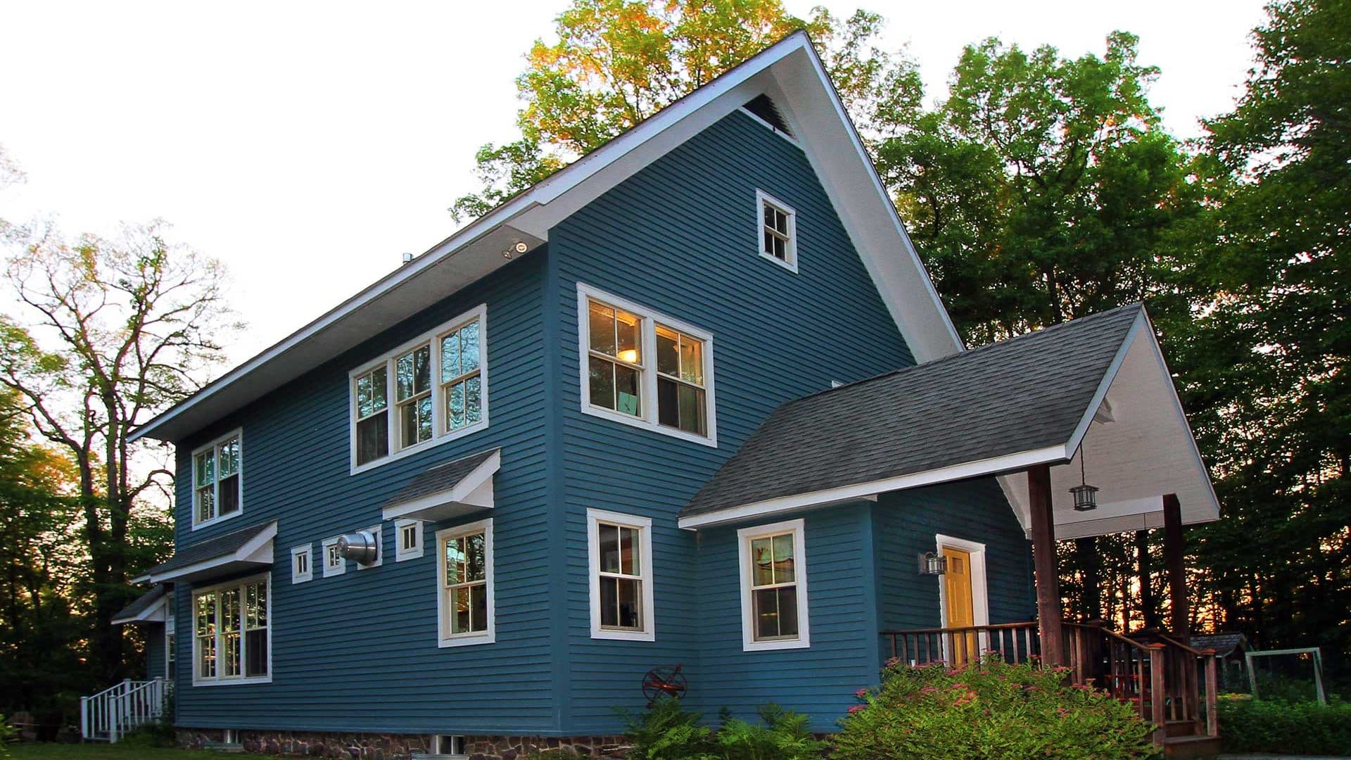 Modern, blue NY home with passive solar design and Geothermal heat